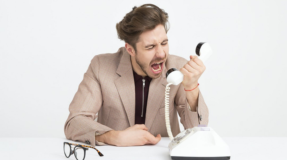 angry man shouting at telephone
