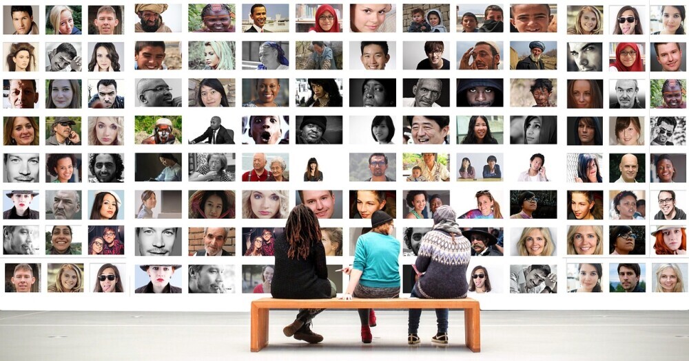 people looking at a wall of diverse images