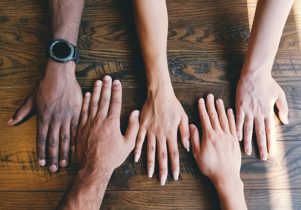 different hands on a table