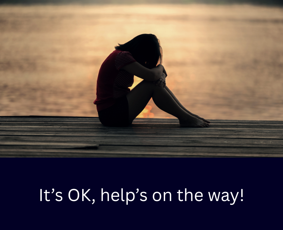 Image of a woman with her head down and a caption: 