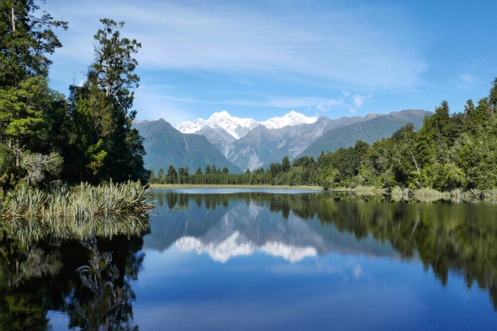 landscape of lakes and mountains reflected in a lake
