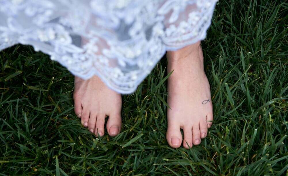 Walking barefoot on grass to explore the summer solstice spiritual meaning