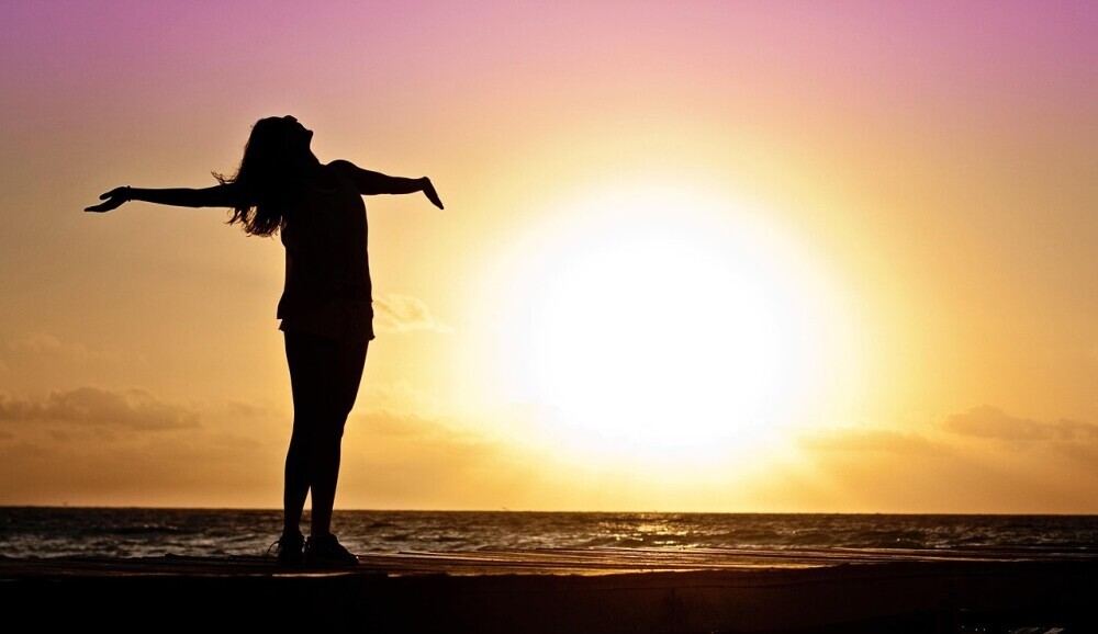 woman celebrating the sunrise
