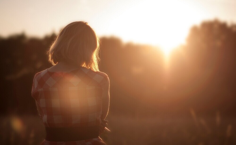 woman looking at a sunset