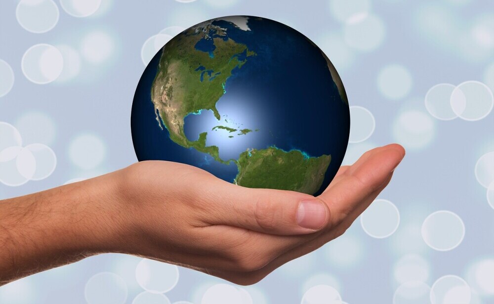 hand holding a model of the Earth