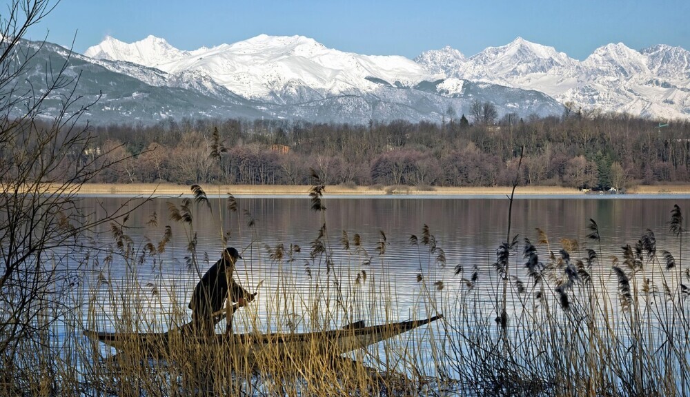 Man on a boat in a mountainous landscape