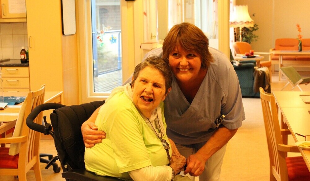 woman helping an elderly person