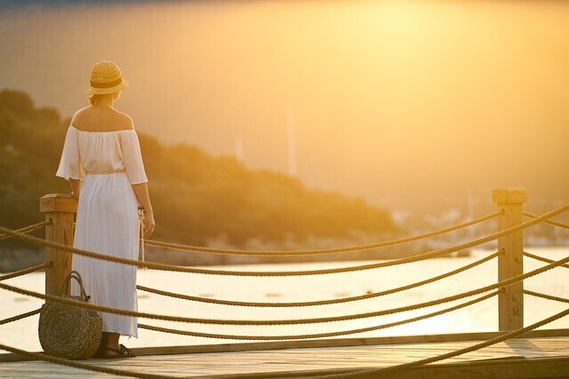 finding time for spiritual practice in a busy life - woman looking at a beautiful sunset