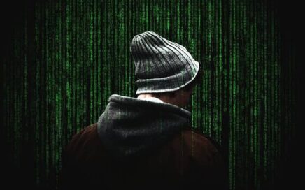a man in a coat and hat looking at matrix-like screen where green numbers and symbols are cascading down